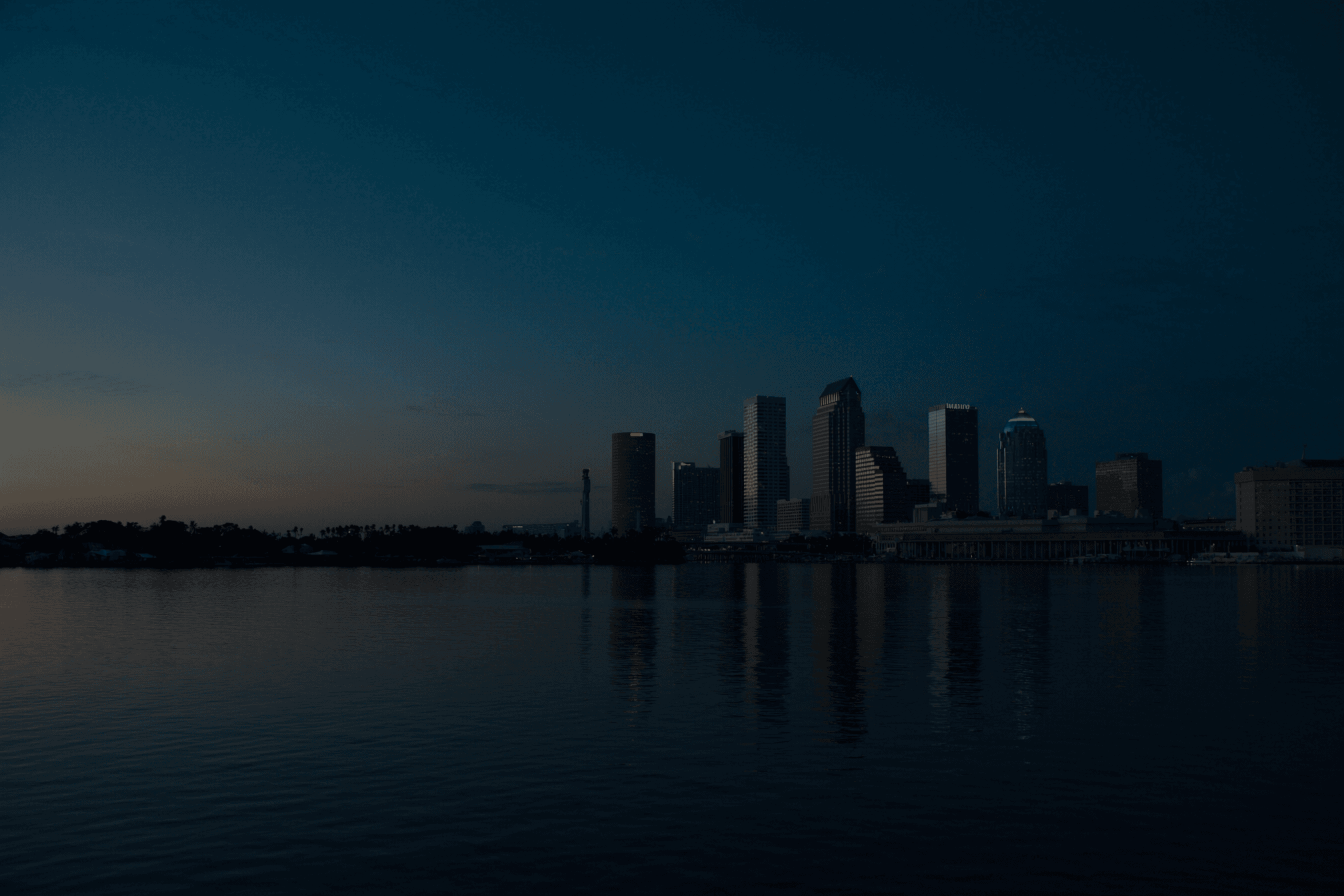 The downtown Tampa skyline across the water at dusk